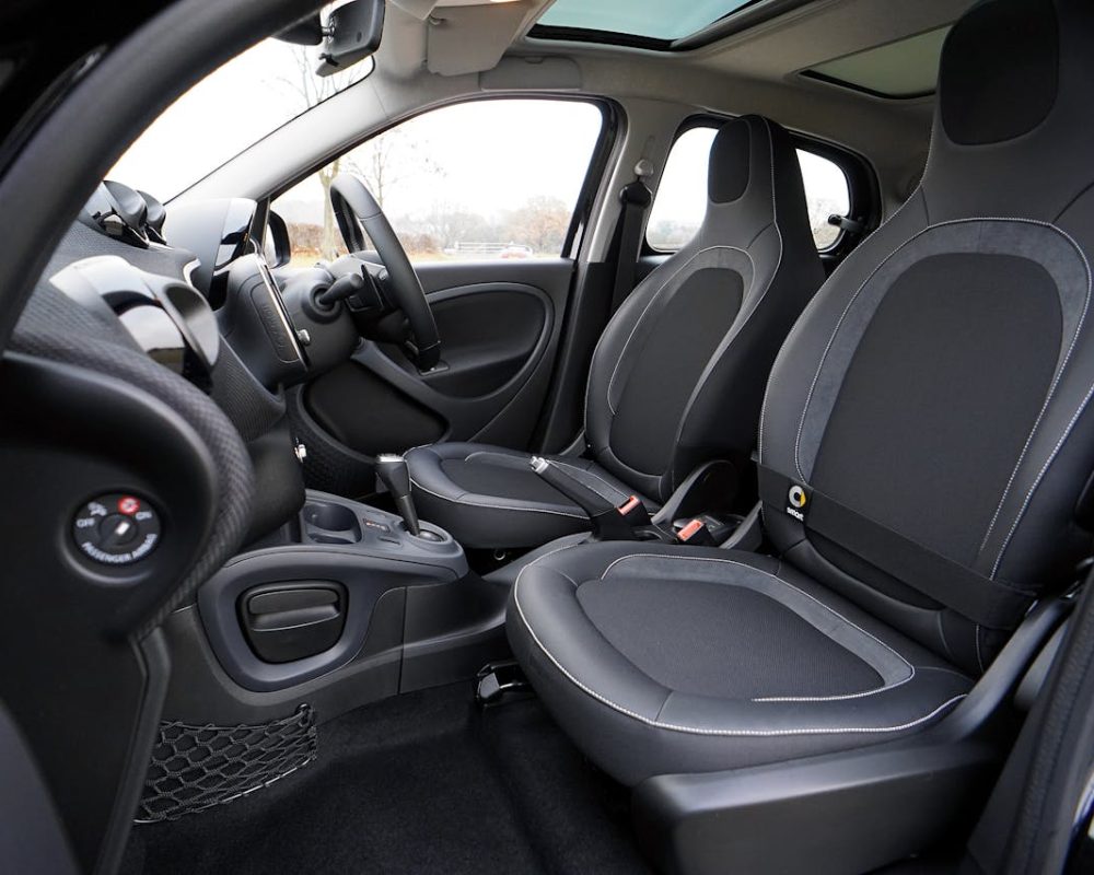 Explore the sleek interior of a modern luxury car featuring leather seats and advanced technology.