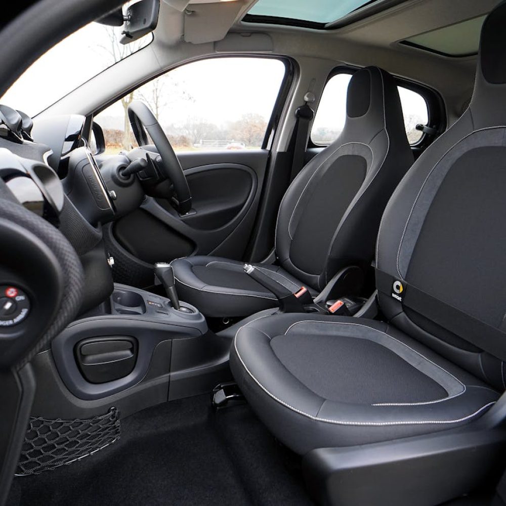 Explore the sleek interior of a modern luxury car featuring leather seats and advanced technology.